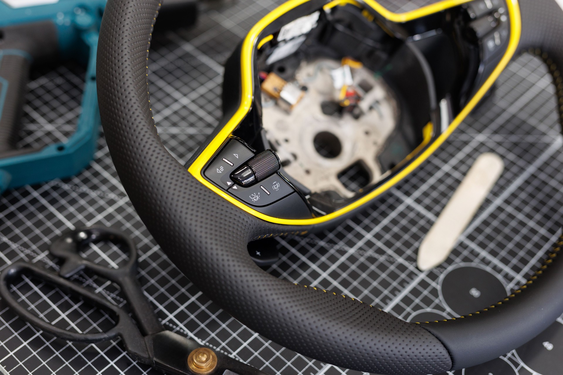 Repair of a leather car steering wheel in an auto repair shop on the table. Car Airbag